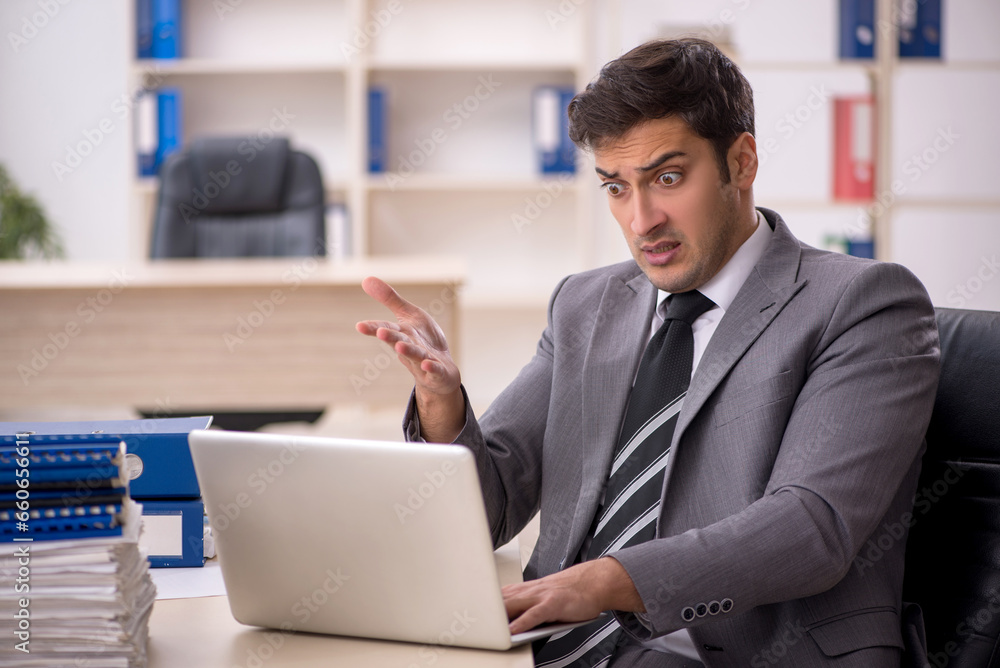 Young male employee working in the office Young male employee working in the office