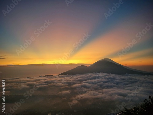 Batur mountain top sunrise above the cloud