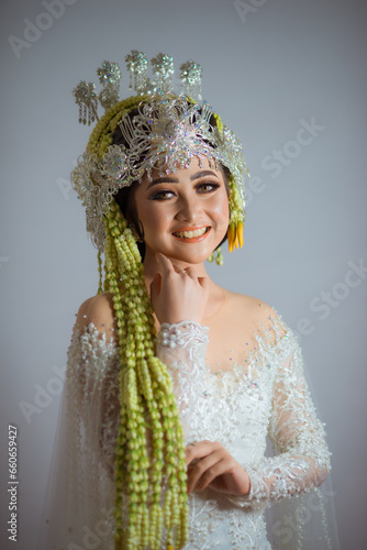 Amazing smiling bride. Traditional Javanese Bridal Portrait. Indonesian bride. Wedding day bride in wedding dress. Beautiful bride. Beautiful model. Javanese wedding dress. Akad Nikah Dress. photo