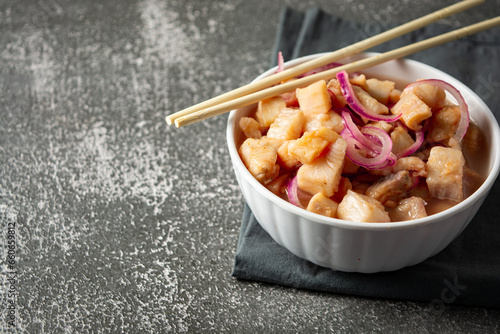 fish ceviche with onions and pepper. traditional peruvian food with tigra milk photo