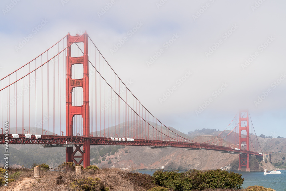The iconic view of the Golden Gate Bridge from South side of the bridge at day time, San Francisco, CA. Picturesque panorama on Golden Gate National Recreation area and Battery Spencer over the bridge