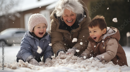 Grandmother plays snowballs with his grandchildren in winter.