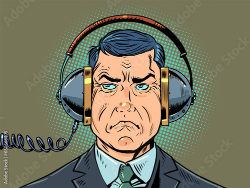 Problems of security and privacy of the modern world. State surveillance of the actions of its citizens. A strict man in a suit eavesdrops on other people's conversations through headphones.