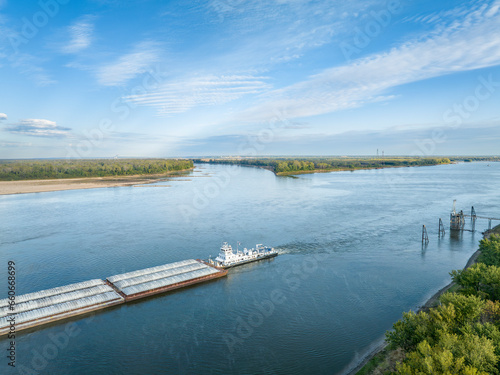 towboat with barges on the Mississippi River at confluence with the Missouri River below Alton, IL photo