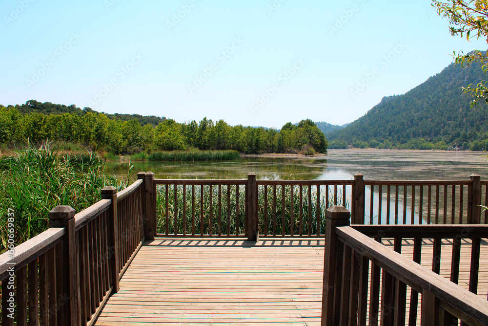 Wooden pier by the lake. Wood dock on the lake. National park in Turkey.