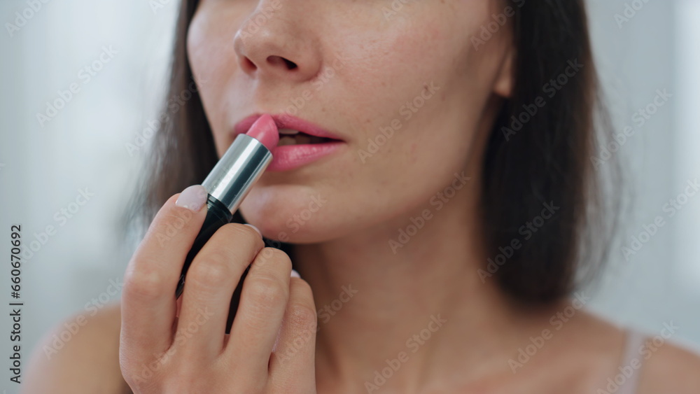 Portrait model applying lipstick home. Happy lady making makeup using lip care