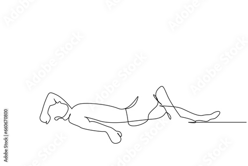 Calm man is lying on the ground sunbathing and resting. sick man resting on the floor holding his head