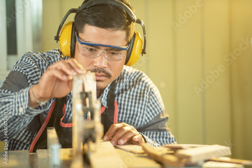 Portrait of a carpenter working in a workshop, Thailand photo