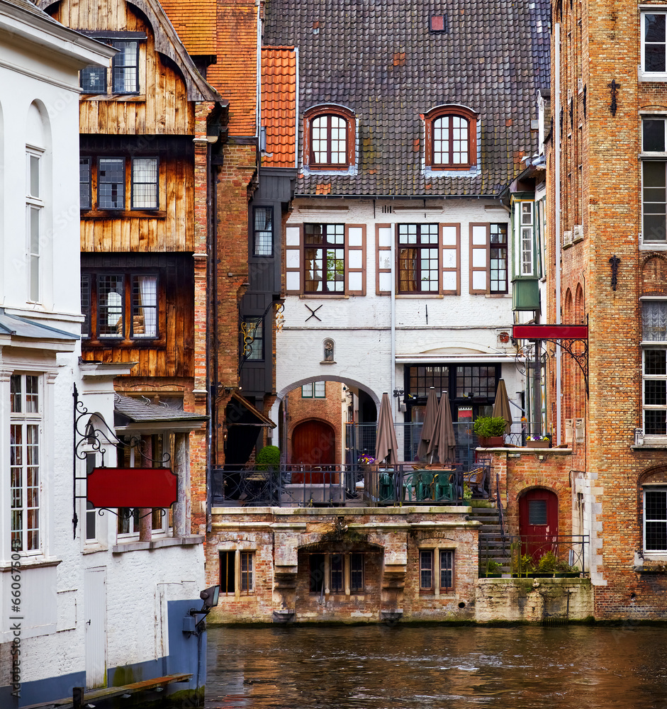 Fototapeta premium Bruges, Belgium. Ancient medieval architecture. Old stone and wooden houses above water channels in Brugge. Historic town, famous european landmark