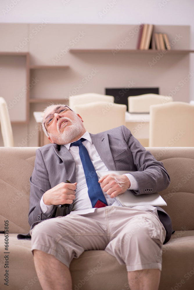 Old male employee working from home during pandemic Old male employee working from home during pandemic