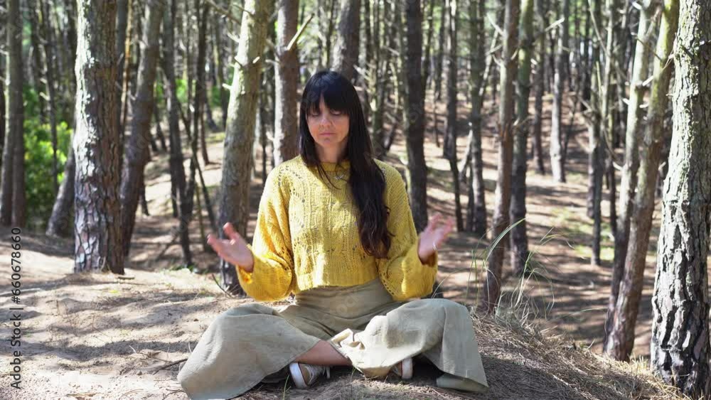 Woman with hands clasped meditating on the woods. Woman with hands clasped meditating on the woods.