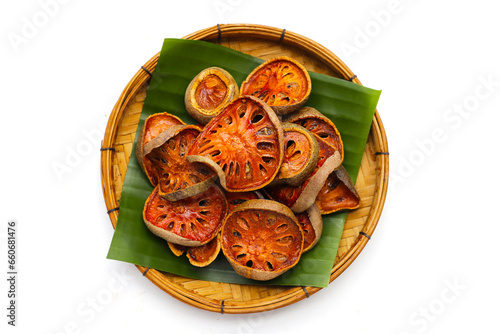 Dried bael fruit slices on white background. photo