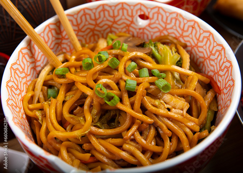 Veggie lo mein noodles in a bowl with chopsticks