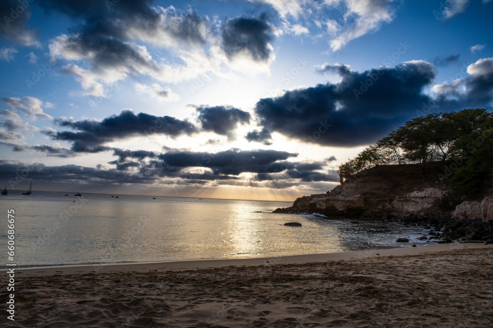 Streaming sun through clouds as sun is setting on Tarrafal beach Cape Verde Streaming sun through clouds as sun is setting on Tarrafal beach Cape Verde