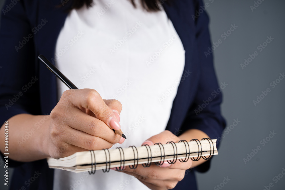 Woman writing in a notepad
