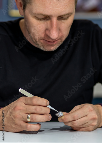 Jeweler working on a ring with stones.