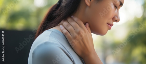 The woman suffers from pain in the neck joints photo