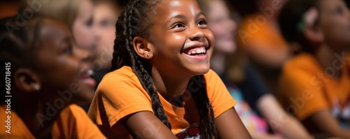 Closeup of a young camper eagerly listening to a guest speaker share their testimony and how their faith has helped them overcome challenges in their life.