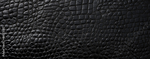 Closeup of reptileembossed leather in a classic black shade, featuring a finelyembossed sskin pattern that adds subtle dimension and texture to the surface.