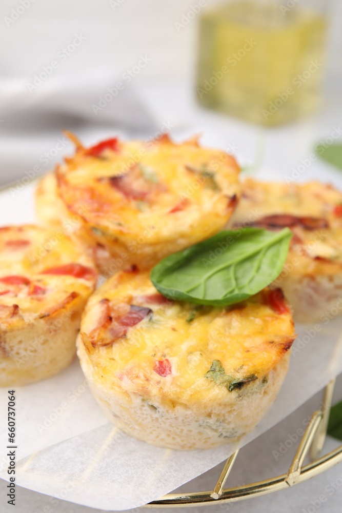 Freshly baked bacon and egg muffins with cheese on table, closeup Freshly baked bacon and egg muffins with cheese on table, closeup