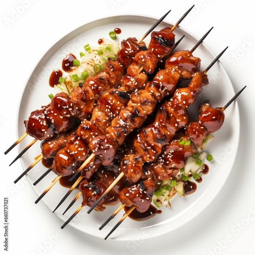 A platter of succulent teriyaki chicken skewers on a white background
