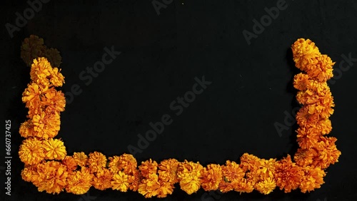 Stop-Motion Animation of a Day of the Dead Marigold frame.These bright orange flowers contrast beautifully against the deep black background, creating a visually striking image with ample copy space 