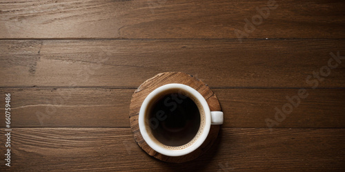 Top view of a cup of coffee on the wooden table, coffee background with copy space