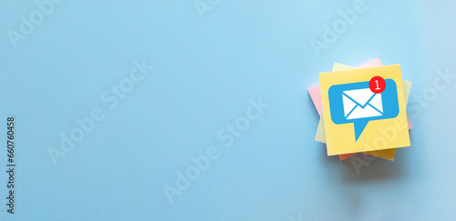 Marketing,Business,Financial,Email nontification,Social media concept.,Letter with speech bubble icon on sticky note over blue background idea for communication,reminder,internet. photo