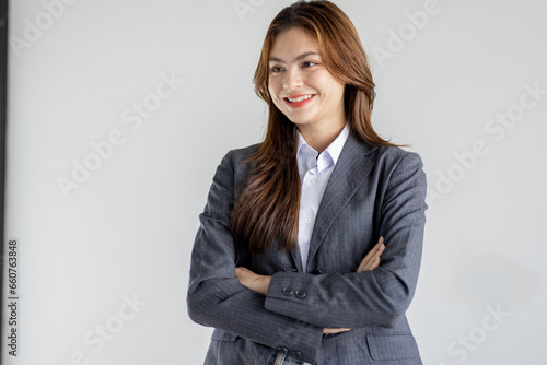 Asian businesswoman hoding digital tablet standing in office isolated on white background, Smiling woman executive manager, Feeling happiness.