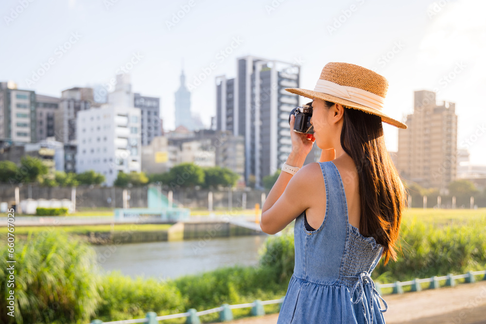 Travel woman visit Taipei city use digital camera to take photo