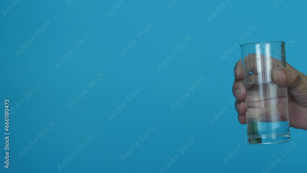 Grandson takes care of his grandfather, looks after him and gives him a glass of water.