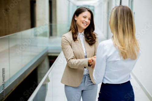 Two young business women ha...