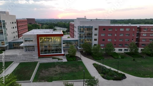 Modern college dormitories in university campus in USA. Aerial establishing shot of student housing at dusk during sunset. photo