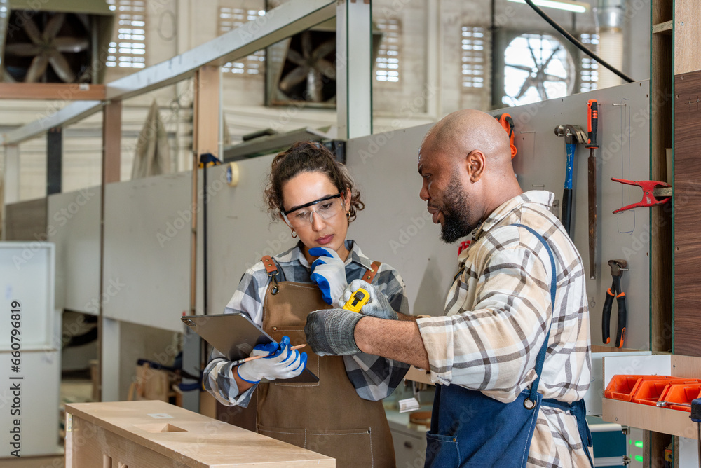 Two colleague young aged carpenter standing aim equipment tool for wood furniture at wood plank in workshop. coworker carpenter working craft with wood diy tool in workbench shop carpentry