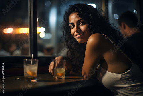 Lonely young woman sitting alone in bar with glass of beer in pub and restaurant with low light place, sad and depression alcoholism concept