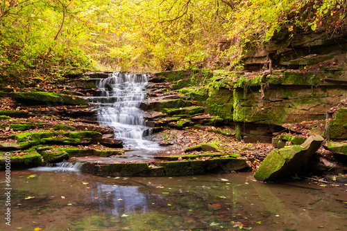 A small cascading waterfall in a mountain stream in the forest. One of the waterfalls of the cascade of Rusiliv waterfalls. Rusyliv, Ternopil Region, Ukraine photo