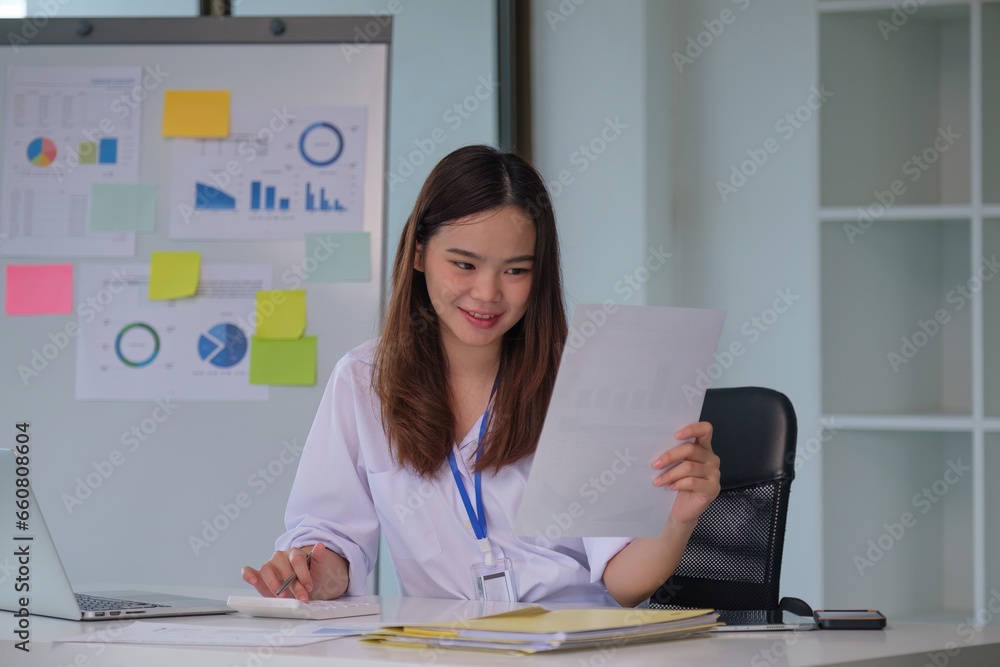 © itchaznong - Woman working and analysis finance document report. business strategy concept