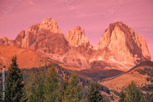 Mountain landscape in the evening. The Dolomites Alps against the sunset sky. Sella Pass, Grohmannspitze, Selva di Val Gardena, Bolzano, Italy