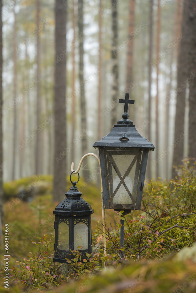 Two grave lanterns in a misty forest