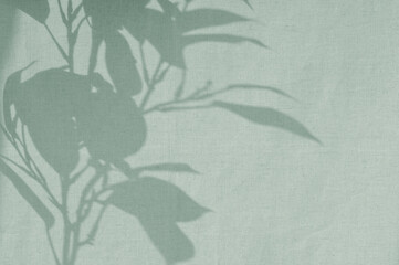 Beautiful natural floral sunlight shadow on sage green colored linen texture cloth background. Aesthetic sustainable eco business brand template