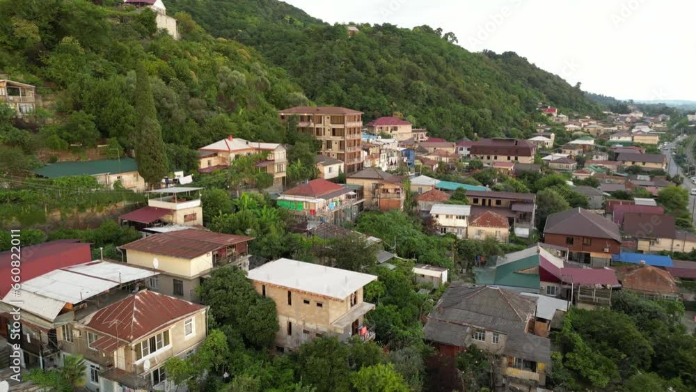 Aerial view of houses between mountains covered by the woods. Top view of Gagra in Abzakhia. Aerial view of houses between mountains covered by the woods. Top view of Gagra in Abzakhia.