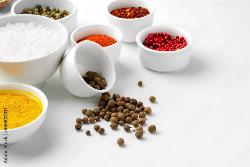 Various spices in a bowls on white background Various spices in a bowls on white background