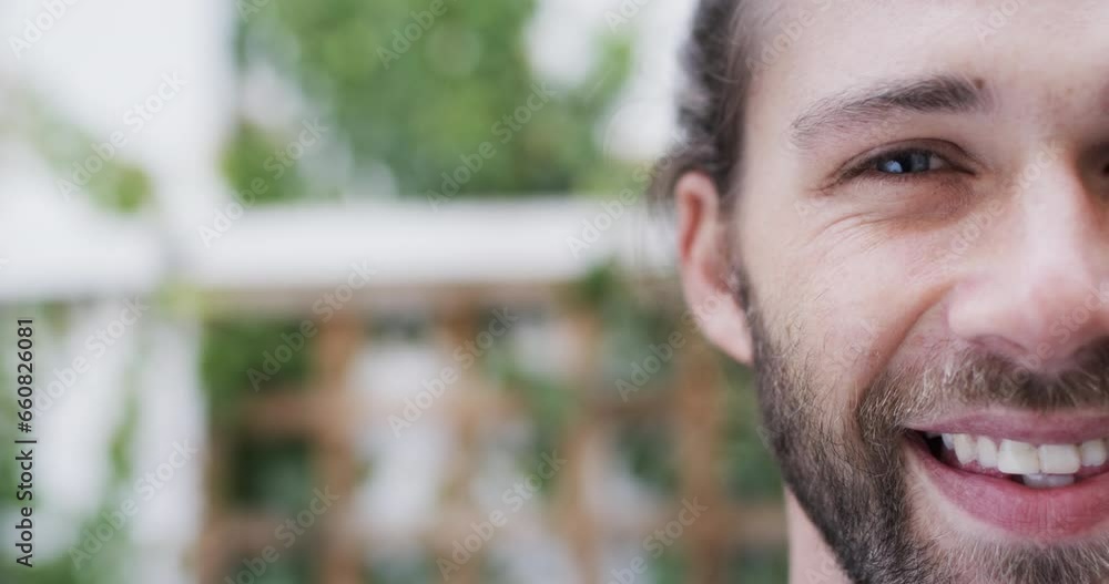 Portrait of happy caucasian man smiling in garden, slow motion, copy space Portrait of happy caucasian man smiling in garden, slow motion, copy space