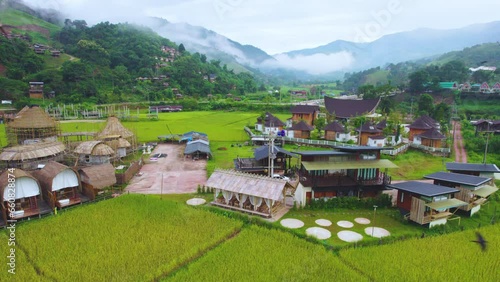 Aerial drone view of Small village captured in morning with fog at Ban Sapan, Small village in Nan, THAILAND.