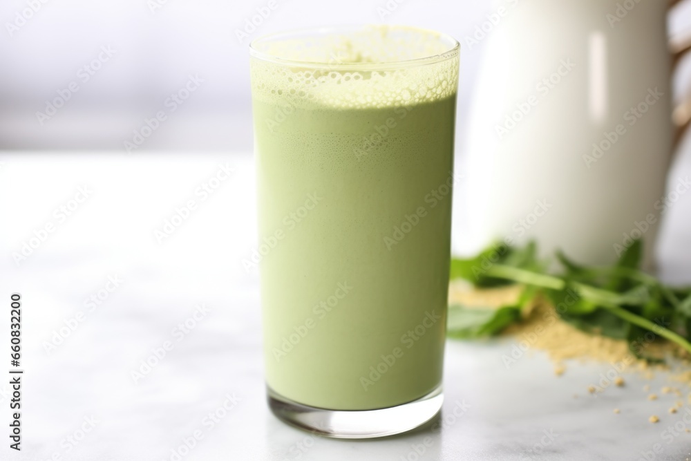 matcha latte in a tall glass, mint sprig on top matcha latte in a tall glass, mint sprig on top