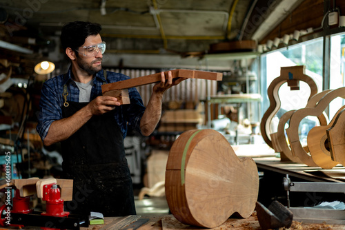Guitar Luthier Examines Wood for Acoustic Guitar Neck