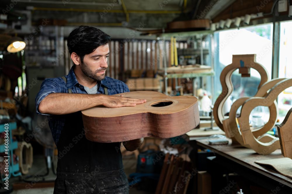 Luthier Taps Spruce Top of Unfinished Acoustic Guitar to Check Sound