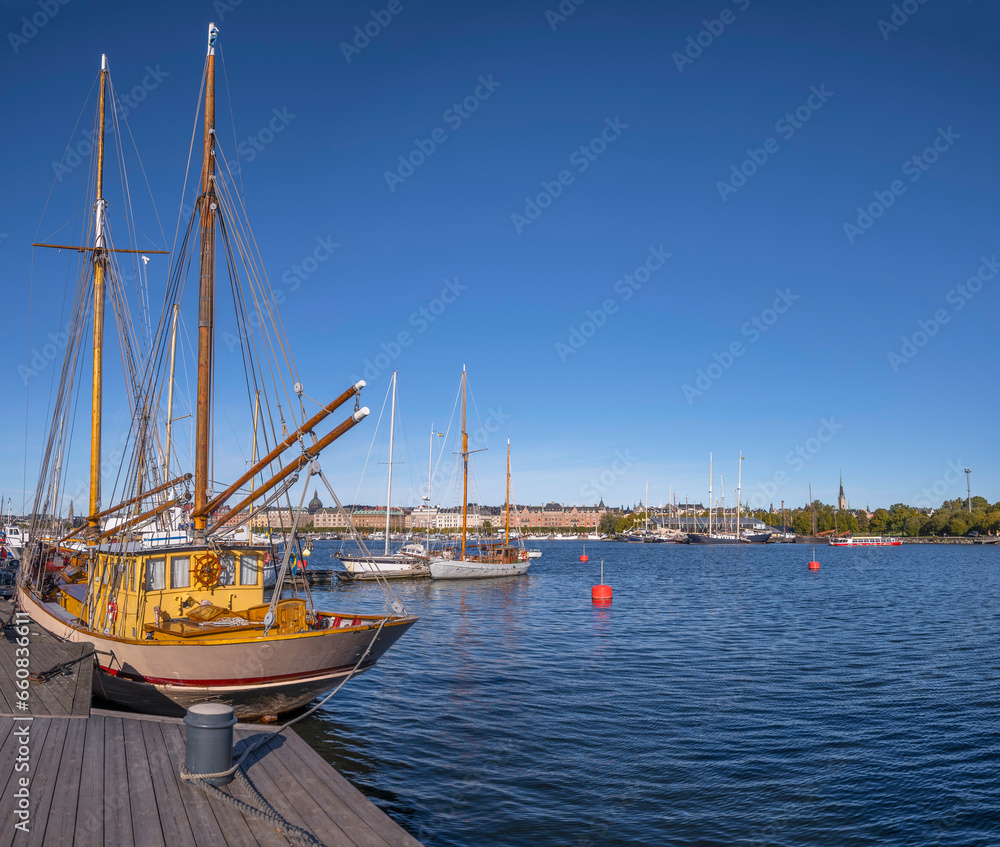 Moored sailing boat at a pier on the island Skeppsholmen, a sunny autumn day in Stockholm Moored sailing boat at a pier on the island Skeppsholmen, a sunny autumn day in Stockholm