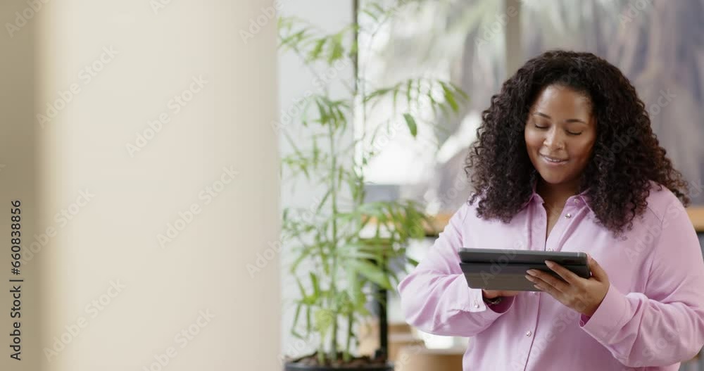 Casual biracial businesswoman using tablet in office, slow motion with copy space Casual biracial businesswoman using tablet in office, slow motion with copy space