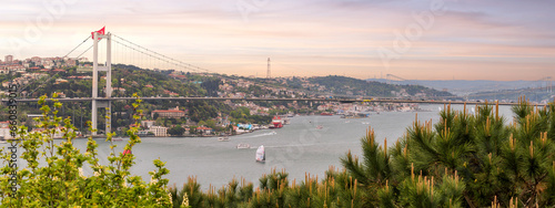 Aerial dawn shot of Istanbul city from Fethi Pasha Grove overlooking Bosphorus strait, with Bosphorus Bridge, or Bogazici Koprusu, connecting Europe and Asia, Istanbul, Turkey photo